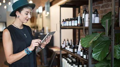 Person checking inventory on tablet