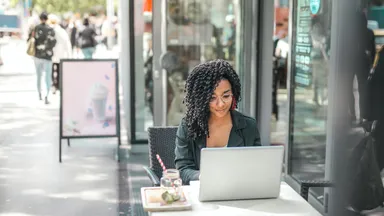 woman on laptop outside 